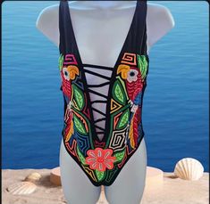 One piece swimsuit. This unique piece is made with authentic mola by indigenous women from Guna Yala Panama. Note: For sanitary reasons, swimsuits cannot be changed or returned. Please check the sizes before purchasing. (85% Nylon, 15% spandex, hand wash) Approximate measurements: Size M Bust: 29" Waist: 28" Hip: 30" Suit length: 26.5" --------------------- Approximate measurements: Sizes Bust: 30" Waist: 28" Hip: 30" Suit length: 25.5" Bohemian Sleeveless Swimwear For Swimming, Bohemian Fitted Swimwear For Festival, Bohemian Fitted Festival Swimwear, One-piece Swimwear For Beach Festival, Bohemian Fitted One-piece Swimwear, Multicolor One-piece Swimwear For Festival, Bohemian Sleeveless Swimwear For Festivals, Sleeveless Swimwear For Beach Festivals, Multicolor Sleeveless Swimwear For Festivals