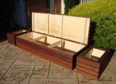 an open wooden box sitting on top of a patio