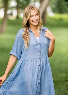 The Brenna Chambray Tiered Shirt Midi Dress is the perfect dress to wear to go on a walk, enjoy a cup of coffee at a park or grab brunch with your friends! The chambray style and button-down design offer a chic and trendy look, while the sleeves land at the elbows for a laid back style! Pair with sneakers, sandals, wedges, or booties for a look that is as unique as you! Style | Short Sleeve, Midi Color | Blue SIZING TIPS Fit | Loose Fit Stretch | None Model | True to Size Shirt Midi Dress, Sandals Wedges, Professional Wardrobe, School Dresses, Church Dresses, A Cup Of Coffee, Midi Shirt Dress, A Park, Laid Back Style