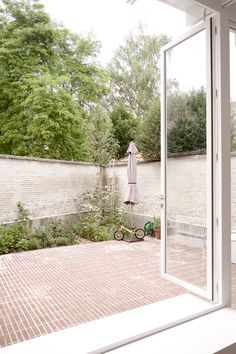 an open window with a bike parked in front of it