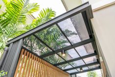 a house with wooden slats and green plants