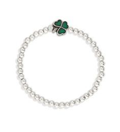 Handmade using genuine 6mm semi- precious beads and flexible stretch cord.7-1/2" unstretched circumference (similar in size to our "Regular" sized bangle bracelet | We've got to tip our hat to this one. Our Lucky Shamrock Stretch Bracelet delivers maximum charm with minimal fuss in a dainty stretch beaded design and eye- catching emerald- colored accent. | 1-800-Flowers Everyday Gift Delivery Luca + Danni Lucky Shamrock Stretch Bracelet Silver Tone Lucky Shamrock, Gift Delivery, Precious Beads, Irish Jewelry, Everyday Gifts, Semi Precious Beads, Bracelet Silver, Bead Designs, Gold Plated Silver