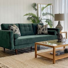 a living room with a green couch and coffee table