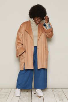 The Hilmar is a long, oversized jacket, falling to the mid-thigh. Oversized features make it iconic: large, patch pockets; side vents; a stepped hemline; and wide, turned-back cuffs. Beautifully lined, this jacket looks easy-going, and feels luxurious.Corduroy’s distinct quality comes from its ribs, or ‘wales’. Corduroy fabric can come in different thicknesses, depending on the width of its wale. Narrow-wale corduroy is fine and light. Wide-wale corduroy is chunky and fluffy-soft.In Beige, the corduroy is a wider wale. In Blue, the corduroy is narrower. The Burgundy sits in the middle of the two. Whichever you pick, these organic cotton corduroys look great, feel great and will stay soft and durable.Each jacket is numbered and production is limited to 100 pieces per colourway.Inclusive siz Oversized Solid Outerwear With Pockets, Beige Outerwear With Side Pockets, Oversized Beige Outerwear With Side Pockets, Beige Long Coat With Button Cuffs, Beige Relaxed Fit Outerwear With Lapel Collar, Oversized Solid Single Breasted Outerwear, Beige Relaxed Fit Single Breasted Outerwear, Beige Single Breasted Outerwear With Relaxed Fit, Beige Single Breasted Relaxed Fit Outerwear