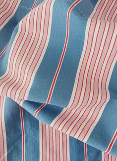 the fabric has red and blue stripes on it, as if they were made out of denim