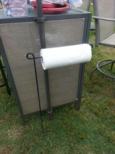 an image of a screen with the text use a garden flag holder to hold your paper towels when camping