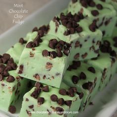 mint chocolate chip fudge bars stacked on top of each other in a white container