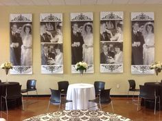 a room filled with tables and chairs covered in white tablecloths next to pictures on the wall