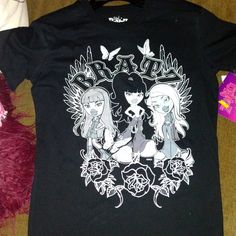 Black And White Bratz T-Shirt Nwt Emo Crew Neck Top With Anime Print, Edgy Anime Print Crew Neck Tops, Edgy Anime Print Short Sleeve Tops, Emo Anime Print Crew Neck Top, Black Punk T-shirt With Anime Print, Punk Black Tops With Logo Print, Black Anime Print Tops For Streetwear, Edgy Black Top With Front Print, Edgy Black T-shirt With Anime Print