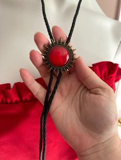 Bolo adjustable vintage tie made of leather. The focal is a red sun symbol  Measures 36 inches  The leather is braided and can be worn for man or woman  For more gift ideas: Www.Etsy.com/shop/Ashley3535 Western Style Red Jewelry As Gift, Bolo Vintage, Earrings Stones, Devil Fruit, Sun Symbol, Bolo Ties, Red Sun, Vintage Tie, Bolo Tie