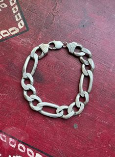 "* Vintage Italian handmade sterling silver cuban curb link chain bracelet.  * Stamped \"Italy\", and \".925\".  * Bracelet measures at 9.5 inches long. Each small link measures at .85 inch long x .55 inch wide.  * Weight- 64.4 grams Please view and inspect the photos closely, as they are considered part of the condition. I endeavor to fully disclose all condition information clearly, however, please note that what qualifies as excellent condition for historical jewelry differs from modern and contemporary pieces. Minor age wear is typical and to be expected for antique and vintage jewelry. All items are unpolished and in their vintage condition, items can easily be polished up if so desired. Enjoy,  Dev" Formal Silver Cuban Link Bracelet With Curb Chain, Classic Silver Cuban Link Bracelet, Classic Silver Cuban Link Bracelet For Everyday, Classic Silver Cuban Link Bracelet With Oval Links, Everyday Sterling Silver Bracelet With Curb Chain, Classic Cuban Link Silver Chain Bracelet, Silver Figaro Chain Link Bracelet, Classic Sterling Silver Cuban Link Bracelet With Silver Chain, Classic Sterling Silver Curb Chain Bracelet For Everyday