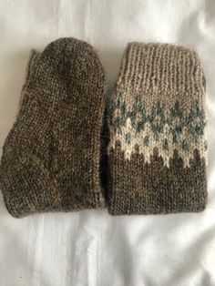 two knitted mittens laying on top of each other