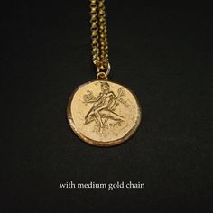 "Greek coin necklace of Taras, the boy riding dolphin. Taras was the son of Poseidon, god of the sea. Most coins of the city bearing his name show the patron deity riding on the back of a dolphin and holding a sea horse. Inscription: TAΡAΣ Greek coin reproduction from 315 - 302 BC Calabria, Tarentum (present day Italy). - Handmade coin reproduction - Solid yellow bronze also called jeweler gold bronze. - One sided coin - Soldered bronze eyelet on top. - Signed in the back by artist - Coin is abo Mythological Medallion Jewelry In Gold, Mythological Style Yellow Gold Jewelry As Gift, Mythological Style Yellow Gold Jewelry Gift, Mythological Style Gold Coin Pendant Jewelry, Gold Mythological Coin Pendant Jewelry, Gold Mythological Jewelry With Coin Pendant, Gold Mythological Engraved Necklace, Gold Engraved Mythological Necklace, Mythological Round Pendant Necklace For Gifts