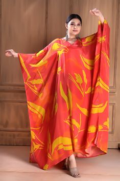 Make a statement in this bold and beautiful V-neck red silk caftan. Crafted from premium silk, this luxurious caftan features a flattering V-neckline that accentuates the décolletage and adds a touch of sophistication. The flowing silhouette drapes elegantly on the body, providing both comfort and style. Whether worn to a formal event or a casual gathering, this red silk caftan is sure to turn heads and make a lasting impression. Step out in confidence and showcase your unique sense of style wit Silk V-neck Dress For Vacation, Elegant V-neck Kaftan For Vacation, Elegant Red Maxi Dress For Eid, Floor-length Flowy Kaftan, Bohemian V-neck Silk Dress, Red Silk Maxi Kaftan, Long Red Kaftan For Eid, Red Silk Maxi-length Kaftan, Silk V-neck Dress For Eid