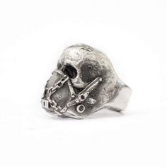 Black Metal Skull Ring Symbolic Style, Symbolic Black Metal Skull Ring, Edgy Black Metal Skull Ring, Edgy Metal Rings For Halloween, Edgy Skull Ring Gift, Edgy Silver Skull Ring As Gift, Gothic Metal Ring For Streetwear, Black Metal Skull Ring For Streetwear, Edgy Silver Skull Ring For Gift