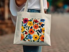 Add a splash of color to your daily errands with this colorful floral tote bag. Featuring a vibrant flower pattern, this reusable grocery bag is perfect for shopping, trips to the beach, or casual outings. Its eco-friendly design and bold flower print make it an eye-catching accessory that combines style and practicality. Product Features: Fabric: 100% Cotton Canvas | Heavy fabric (12 oz/yd² (406.9 g/m Handles: Self-fabric handles with reinforced stitching Size: 15"x16" Inches Floral Tote Bag, Eco Friendly Design, Tote Pattern, Bright Flowers, Vibrant Flower, Friendly Design, Reusable Grocery Bags, Design Floral, Grocery Bag