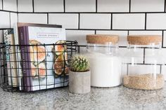 some books and jars on a counter top