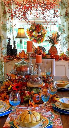 a dining room table set for thanksgiving dinner