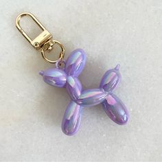 Iridescent Balloon Dog Bag Charm | Key Chain Brand New In Original Packaging Color: Purple & Gold Size (Approx): 3” An Adorable Addition To Your Keys Or Your Favorite Bag! Purple Keychains, Chicken Board, Purple Car, Dog Bag, Balloon Dog, Bag Charms, Car Personalization, Dog Decor, Purple Bags