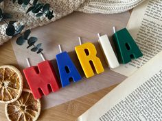 the word mardi gras spelled out in colorful blocks next to sliced oranges