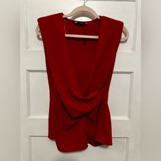 This Beautiful Zara Blouse In Size Medium And Vibrant Red Color Is Perfect For Any Occasion, From Formal Events To Casual Outings. It Features A Sleeveless Design With A Flattering V-Neckline And A Hidden Inseam Side Zip Closure. The Blouse Also Has A Few Unique Accents Such As Ruching On The Sides And Shoulder Pads For A More Structured Look. It Is Made Of Lightweight And Breathable Polyester Material, Making It Ideal For Summer And Spring Seasons. This Blouse Is A Classic Piece That Belongs In Red Sleeveless Tank Top For Night Out, Elegant Red Tank Top For Night Out, Chic Red Tank Top For Night Out, Red Sleeveless Tank Top For Evening, Red Tank Top For Evening, Elegant Red V-neck Tank Top, Red Party Vest Top, Red Sleeveless Party Vest, Zara Tank Top For Parties