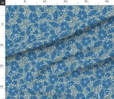 a blue fabric with white dots on it and a ruler in front of the image