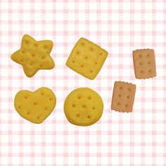 some cookies and crackers are arranged on a checkered tablecloth