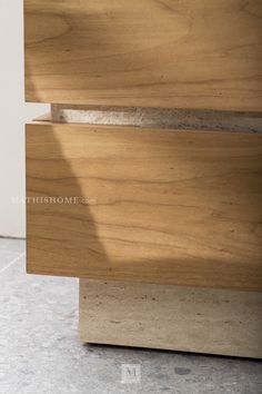 a close up view of the top of a wooden table with marbled flooring