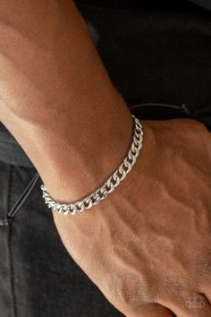 Shiny black cording knots around the ends of a silver beveled curb chain that is wrapped across the top of the wrist for a versatile look. Features an adjustable sliding knot closure. Sold as one individual bracelet. Elegant Mens Jewelry, Mens Bracelet Christian, Mens Jewelry 2022, Bracelet Man Silver, Everyday Metal Bracelets With Sliding Knot, Classic Adjustable Cuban Link Bracelet For Everyday, Adjustable Cuban Link Silver Chain, Minimalist Silver Cuban Link Bracelet Adjustable, Silver Adjustable Cuban Link Bracelet Minimalist Style