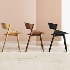 three wooden chairs sitting next to each other on top of a white and beige floor