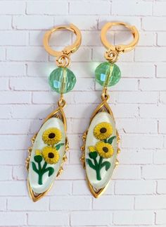 Fascinating vintage Chrysanthemum relief Lucite cabochons mounted on high-end sturdy stamped brass pieces with lustrous faceted beads for a little added shimmer. Classic versatile earrings that will complement so many wardrobe options. If these caught your eye, you may also like the Bluebell https://etsy.me/35X8fJg or the Petunia https://etsy.me/3i9g6Ge These make a special gift too! Thanks for looking! Gold Cabochon Brass Earrings, Gold Brass Cabochon Earrings, Gold Brass Earrings With Cabochon Detail, Vintage Brass Clip-on Earrings For Gift, Vintage Handmade Brass Clip-on Earrings, Handmade Vintage Brass Clip-on Earrings, Handmade Adjustable Vintage Clip-on Earrings, Gold Sunflower Dangle Jewelry, Gold Round Soldered Earrings