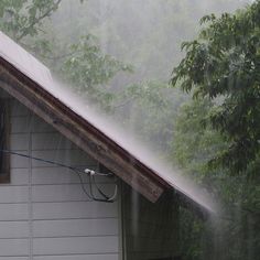 a house that is spraying water on the roof