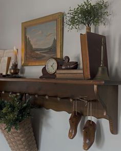 there is a shelf with shoes and a clock on the wall next to a potted plant