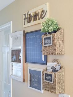 some baskets are hanging on the wall with chalkboards and magnets attached to them