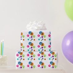 a birthday cake sitting on top of a table next to balloons