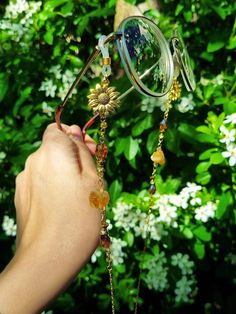 Elevate your eyewear game with our Sunflower glasses chain featuring a stunning mix of citrine crystals and yellow and brown color crystal besds.  This eyeglass chain might be slightly heavier than regular chains because of some stone beads and crystals. Actual colors of any item or chains may slightly differ from screen to screen due to the screen resolution. I take our pictures in natural light during the day. If you want a custom request shoot us a message. We can make these crystal crowns and accessories with any of the crystals we have available (take a look at our shop to get an idea). Check out video footage of item on insta @myshinybox Gold Adjustable Chain Glasses Chains For Festivals, Gold Glass Glasses Chains For Festivals, Handmade Gold Glasses Chains For Summer, Handmade Metal Glasses Chains As Gift, Gold Bohemian Glasses Chains For Summer, Bohemian Gold Glasses Chains For Summer, Bohemian Gold Glasses Chains For Beach, Handmade Glass Glasses Chains In Gold, Handmade Elegant Glasses Chains For Festivals