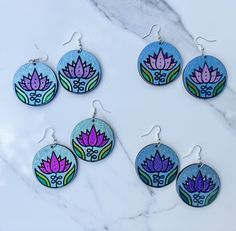 These lightweight wood earrings showcase a sweet little sketch of a lotus flower. They're hand painted with color shifting and holographic watercolor. Earrings are varnished so there's no paint transfer, but they're not waterproof.  Earring hooks are 925 sterling silver plated with silicone backs included.  Four pairs available:  Purple Lotus w/blue green hoLo background  Pink HoLo Lotus w/blue hoLo background  Fuchsia Color Shift Lotus with green hoLo background  Purple HoLo Lotus with blue hoL Holo Background, Lotus Sketch, Fire And Ice Roses, Watercolor Earrings, Coffee Earring, Purple Lotus, Background Purple, Background Pink, Personalized Artwork