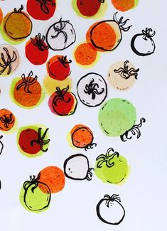 a bunch of cut out tomatoes and oranges on a white surface with black ink