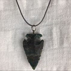 Green Natural Stone Arrowhead Necklace On An Adjustable Dark Gray Cord. Nwot. Maximum Length Is Approximately 15 Inches. Never Worn, But It Appears The Arrowhead Has A Small Chip On The Top Left, Although I Can’t Tell If It’s Supposed To Look Like This Due To The Raw Edges Of It. Tags- Boho, Festival, Hippy, Natural, Earthy Arrowheads Jewelry, Arrowhead Necklace, Boho Festival, Dark Gray, Womens Jewelry Necklace, Natural Stone, Green And Grey, Natural Stones, To Look