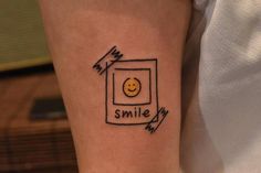 a smiley face drawn on the arm of a person with a smile in front of them