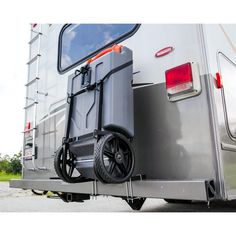 the wheelbarrow is attached to the trailer's rear door and has wheels on both sides