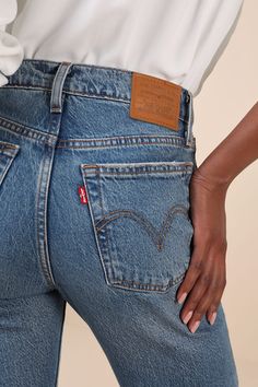 The most stylish 'fits call for a tried and true classic like the Levi's Wedgie Bootcut Medium Wash High-Rise Denim Jeans! Ever-so-slightly stretchy cotton-blend denim (in Levi's Fair Point wash) shapes these timeless jeans that feature a high-rise waist with belt loops, a five-pocket cut, and a branded top button above a hidden button fly. Vintage-inspired bootcut legs boast fading and whiskering for a lived-in effect, before finishing at subtly flared, ankle-length distressed hems. Iconic red Fitted Straight Cropped Jeans In Rigid Denim, Classic Medium Wash Bottoms With Standard Cut Leg, Fitted Dark Wash Cutoff Jeans, Fitted Cutoff Rigid Denim Bottoms, Fitted Cutoff Denim Blue Jeans, Fitted Cutoff Everyday Jeans, Fitted Denim Blue Cutoff Jeans, Fitted Cutoff Cropped Jeans For Fall, Classic Fitted Rigid Denim Jeans