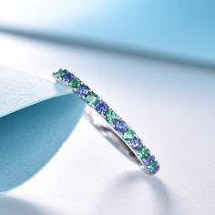 a ring with blue and green stones on it