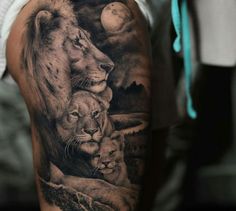 a man's arm with an image of two lions and their cubs on it