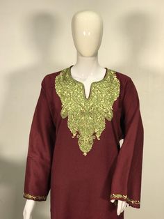 A stunningly marvellous Pheran. This Pheran features intricate Kashmir Aari embroidery on the neckline and sleeves.- - - - - - - - - - - - - - - - - - - - Product Details- Condition: Brand New (made to order)- Style: Pheran Tunic- Fabric: Wool- Colour: Maroon- Embroidery: Aari Work- Embroidery Colour: Green- Standard Length: 40" (100 cm) | Can be customized- Care Instructions: Dry Clean Only**If you want the Tunic to be shorter or longer, just send us a message, and we will tailor it accordingly Elegant Multicolor Embroidered Kurta For Festive Occasions, Elegant Multicolor Embroidery Kurta For Festive Occasions, Festive Multicolor Embroidered Kaftan With Dabka Work, Elegant Designer Kurta With Multicolor Embroidery, Festive Straight Kurta Kaftan With Intricate Embroidery, Semi-stitched Long Sleeve Kurta With Intricate Embroidery, Elegant Salwar Kameez With Multicolor Embroidery And Embroidered Border, Elegant Kaftan With Multicolor Resham Embroidery, Elegant Multicolor Embroidered Kurta For Transitional Seasons