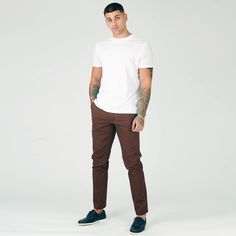 "Looking for a sharp and sophisticated look? Then it would be best if you have a pair of our chocolate brown slim fit chino trousers. These trousers are made from twill fabric, and they have a slim fit that will create a sharp silhouette. They're also stretched for maximum comfort, and they feature a 5-pocket design. Whether you're dressing up for work or heading out for a casual night on the town, these chino trousers are a versatile wardrobe staple. Product Features: Chocolate brown twill fabric Slim fit Stretch Button and zip fly fastening 5-pocket design 98% Cotton, 2% Elastane Our Model is 6'1\" and Wears Size 32, to find the perfect fit for yourself check our Size Guide. Size = 30 - 40 Waist = 79cm - 104cm Hip = 99cm - 106cm Inside Leg = 81cm Waist is measured All Around. Hip is meas Casual Brown Slim Fit Dress Pants, Slim Fit Brown Dress Pants With Tapered Leg, Brown Slim Fit Dress Pants With Tapered Leg, Brown Slim Fit Tapered Leg Pants, Brown Tapered Leg Chinos For Business Casual, Fitted Brown Chinos With Tapered Leg, Fitted Brown Tapered Leg Chinos, Brown Slim Fit Dress Pants For Business Casual, Brown Straight Chinos For Business Casual