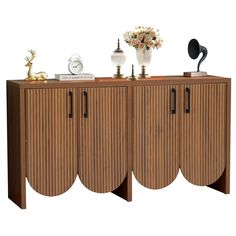 a sideboard with three doors and two vases on top