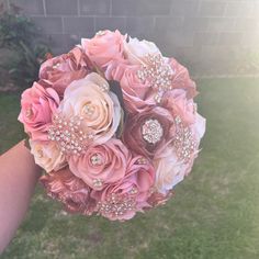 a bridal bouquet with pink roses and pearls