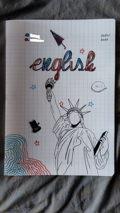 an open notebook with the statue of liberty and words english written in different languages on it