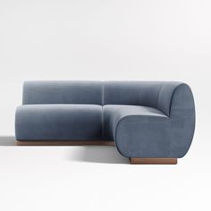 a blue couch sitting on top of a white floor